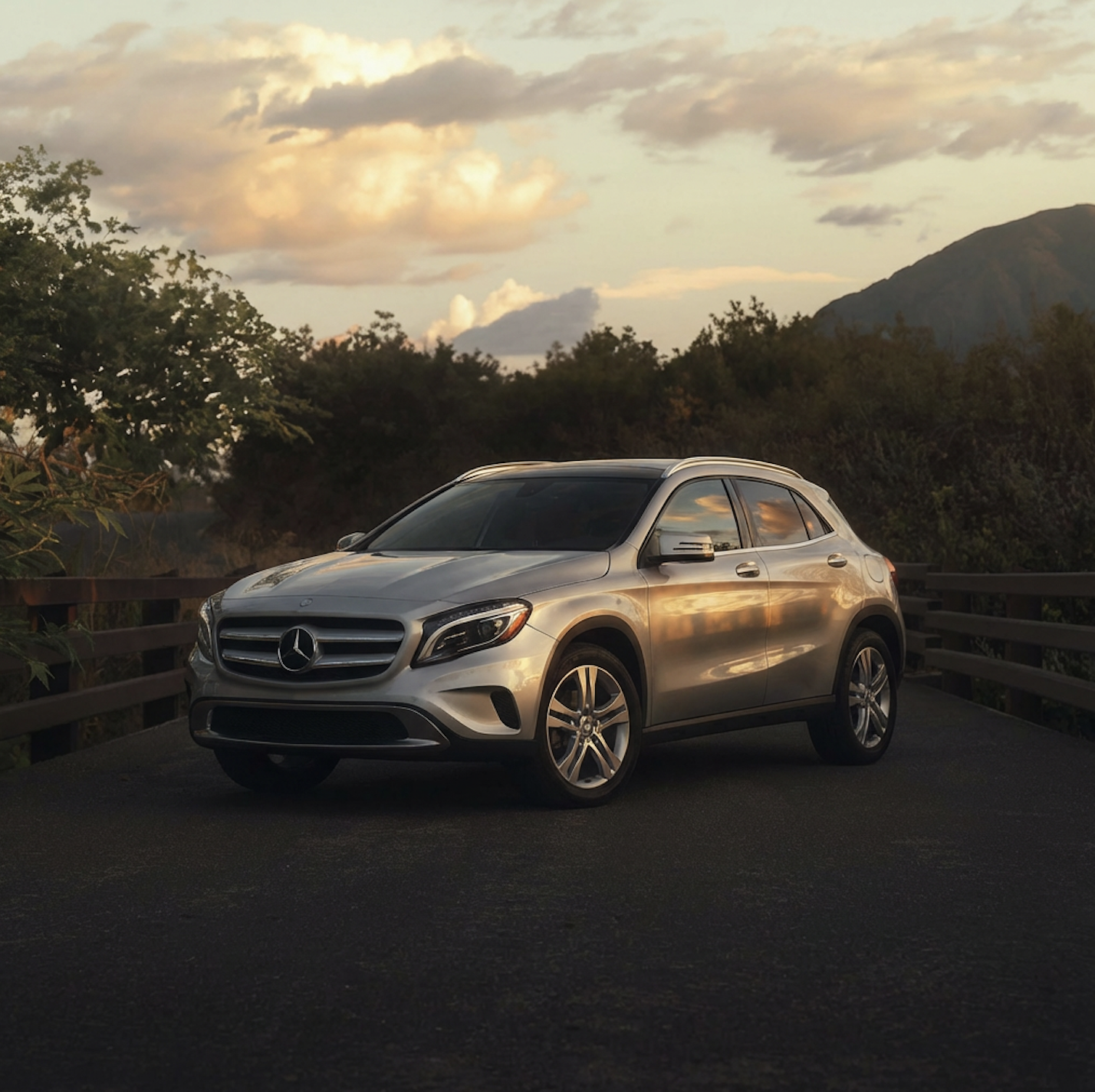 Modern sedan on city street at sunset